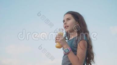 小女孩喝塑料瓶慢动作视频.. 青少年女孩喝果汁和水运动聪明